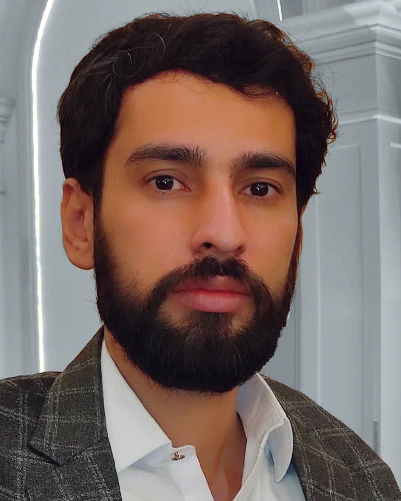 Farhan Akhtar, head and shoulders, in a grey check blazer and an open-collar white shirt.